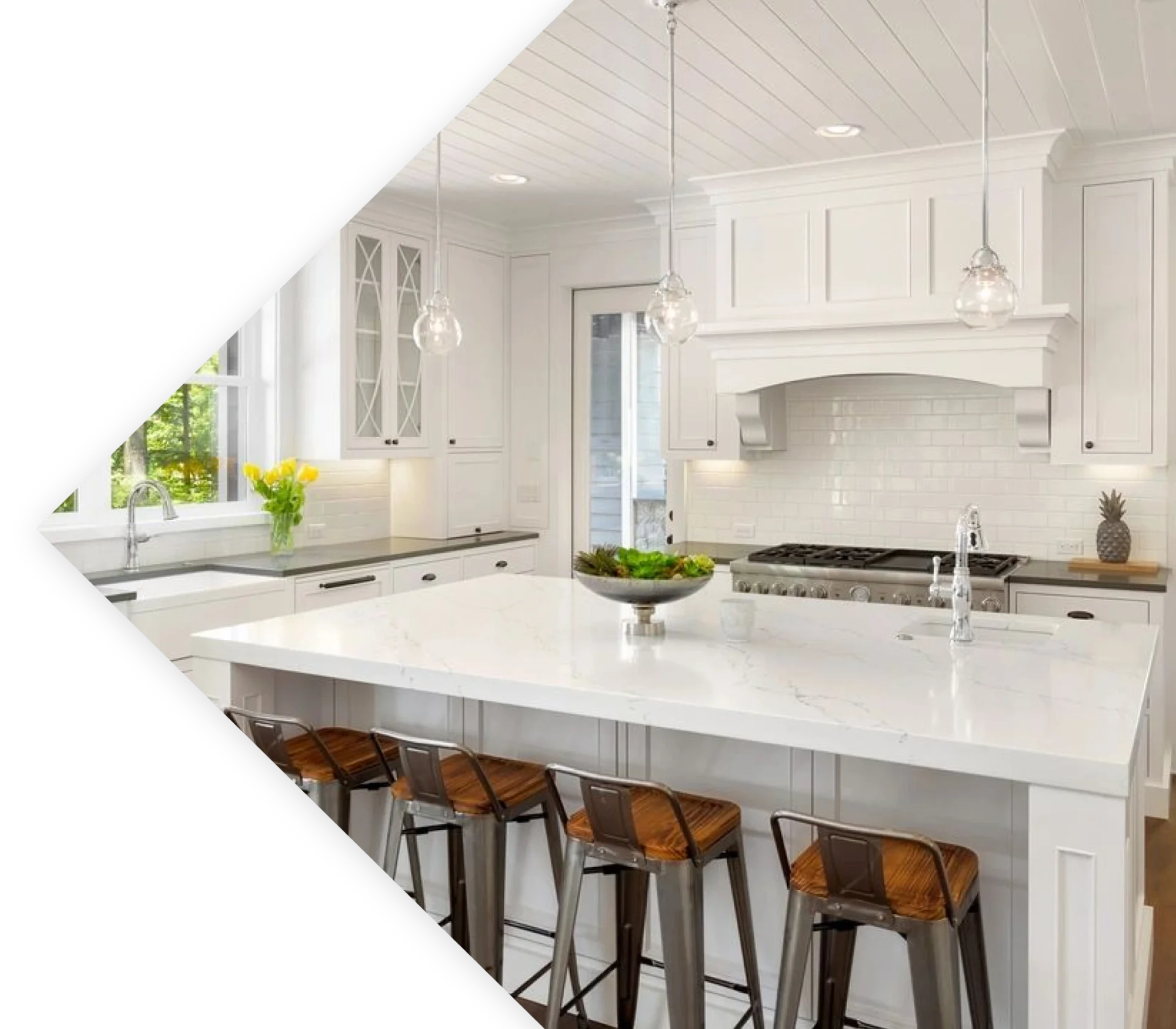 A kitchen with white cabinets and brown stools.