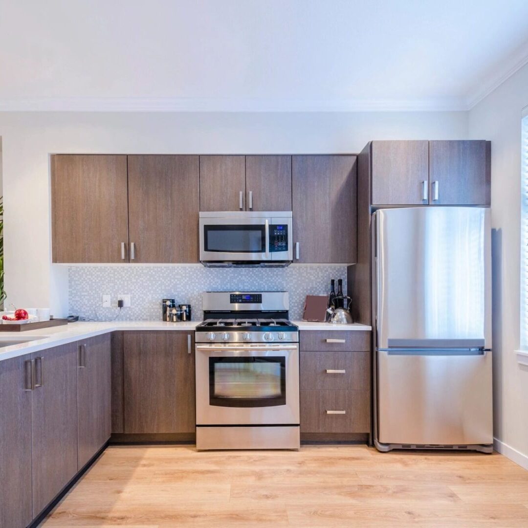 A kitchen with wooden cabinets and stainless steel appliances.