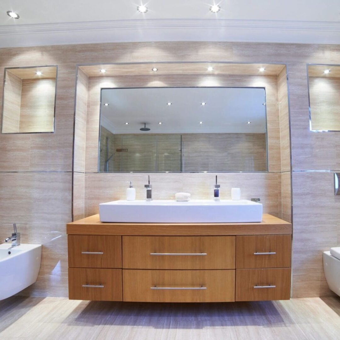 A bathroom with two sinks and a mirror.